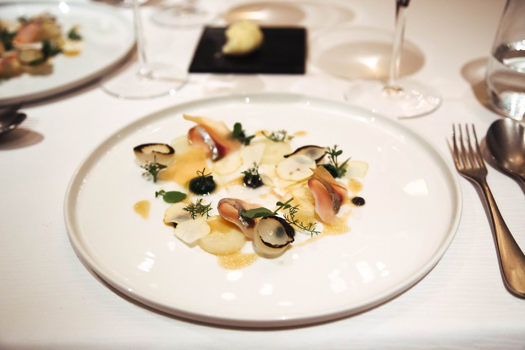 Aji fish, potatoes, chestnuts, truffle puree, parsley puree, and mushroom vinaigrette